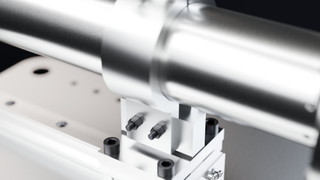 Close-up of the rocket clamp holding the motor on its linear carriage